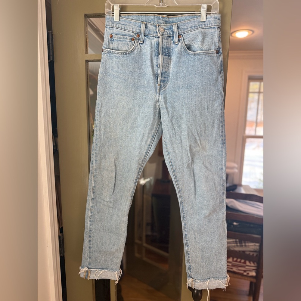 501s Levi’s Strauss Light Wash Blue Jeans with raw hem and button fly, W27 L30